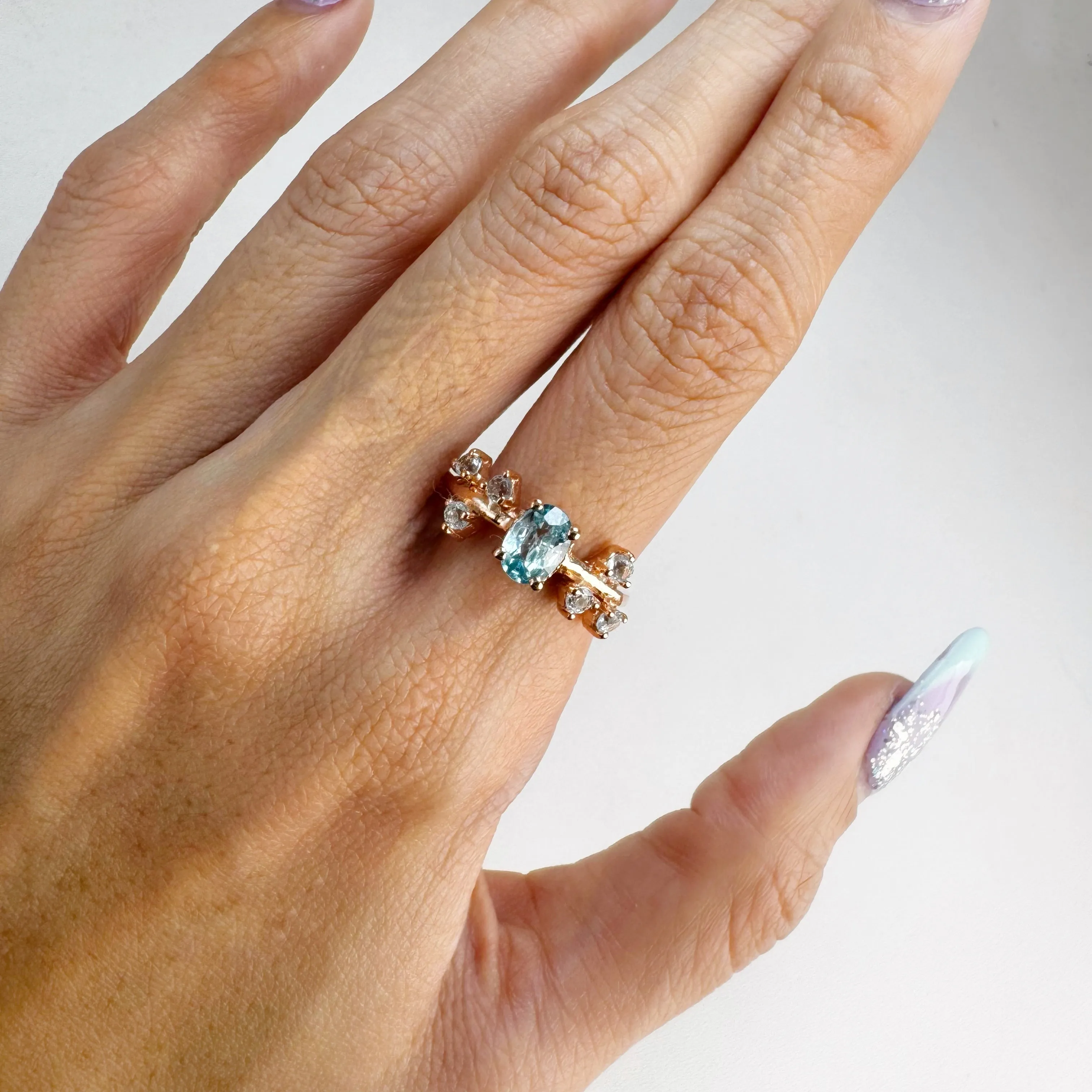 5 x 7 mm. Oval Cut Blue Cambodian Zircon with Topaz Accents Ring