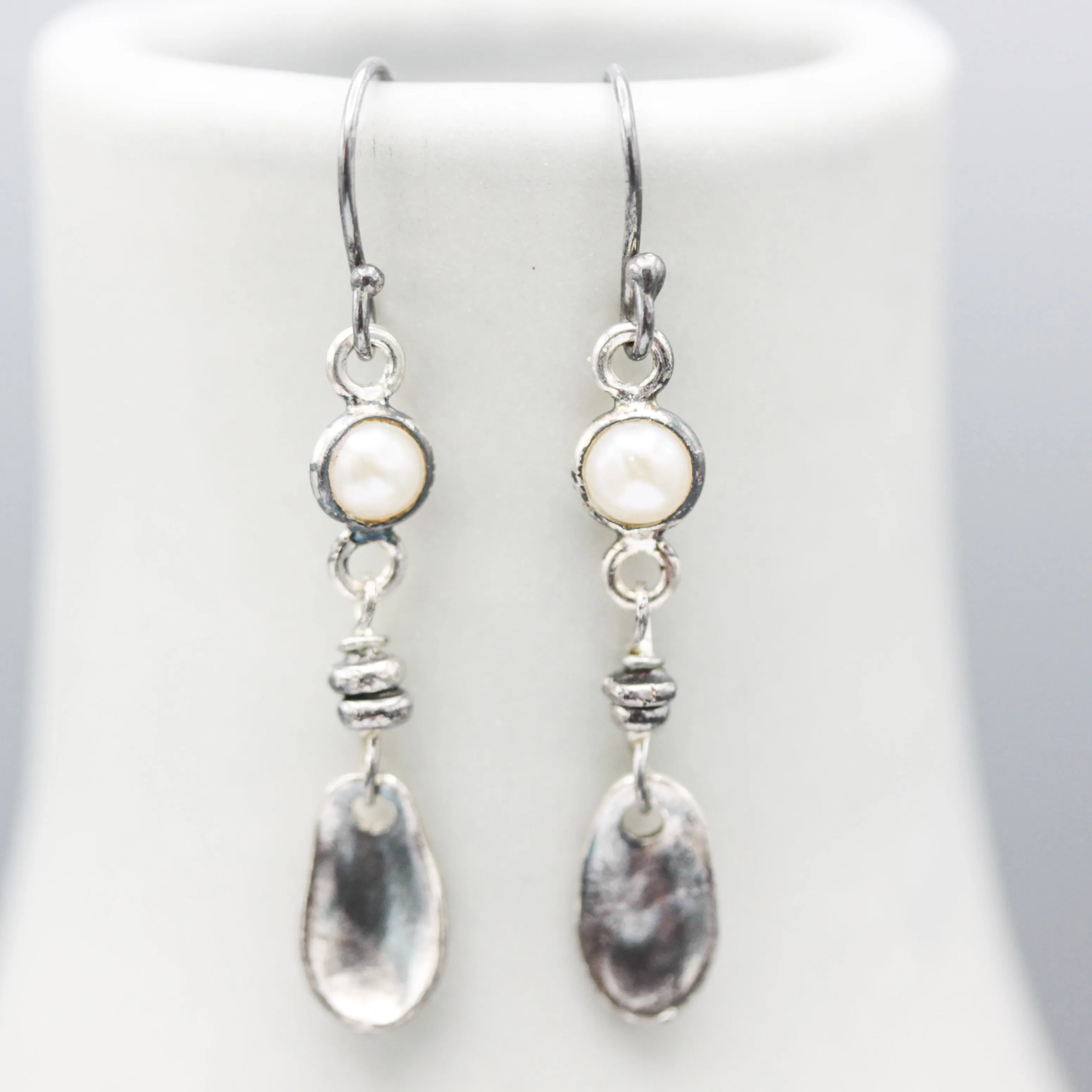 Round white Freshwater Pearls earrings in silver bezel setting with silver leaf on sterling silver hooks style