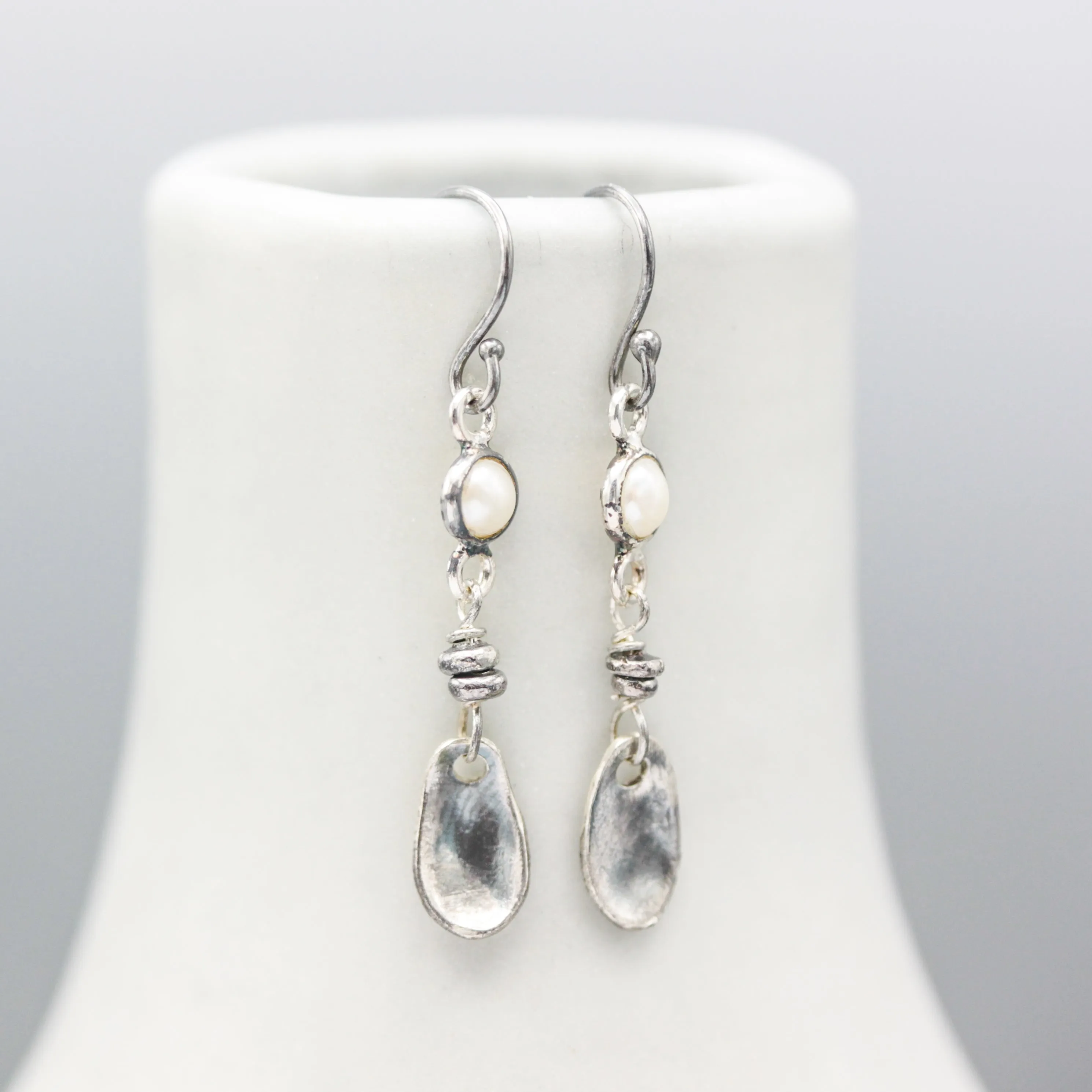 Round white Freshwater Pearls earrings in silver bezel setting with silver leaf on sterling silver hooks style